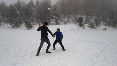 Buz tutan göletin üzerinde kar topu oynadılar