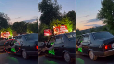 Bursa’nın İnegöl ilçesinde otomobilinin sol ön kapısını açıp, ayağıyla tutarak